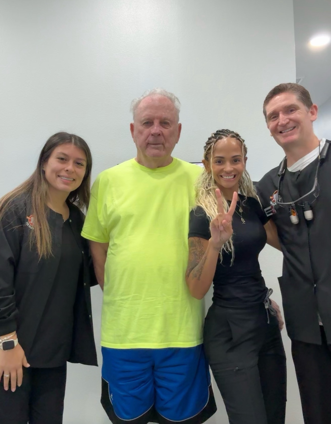 Patient with the dental care team at the Just Pull It Zephyrhills office