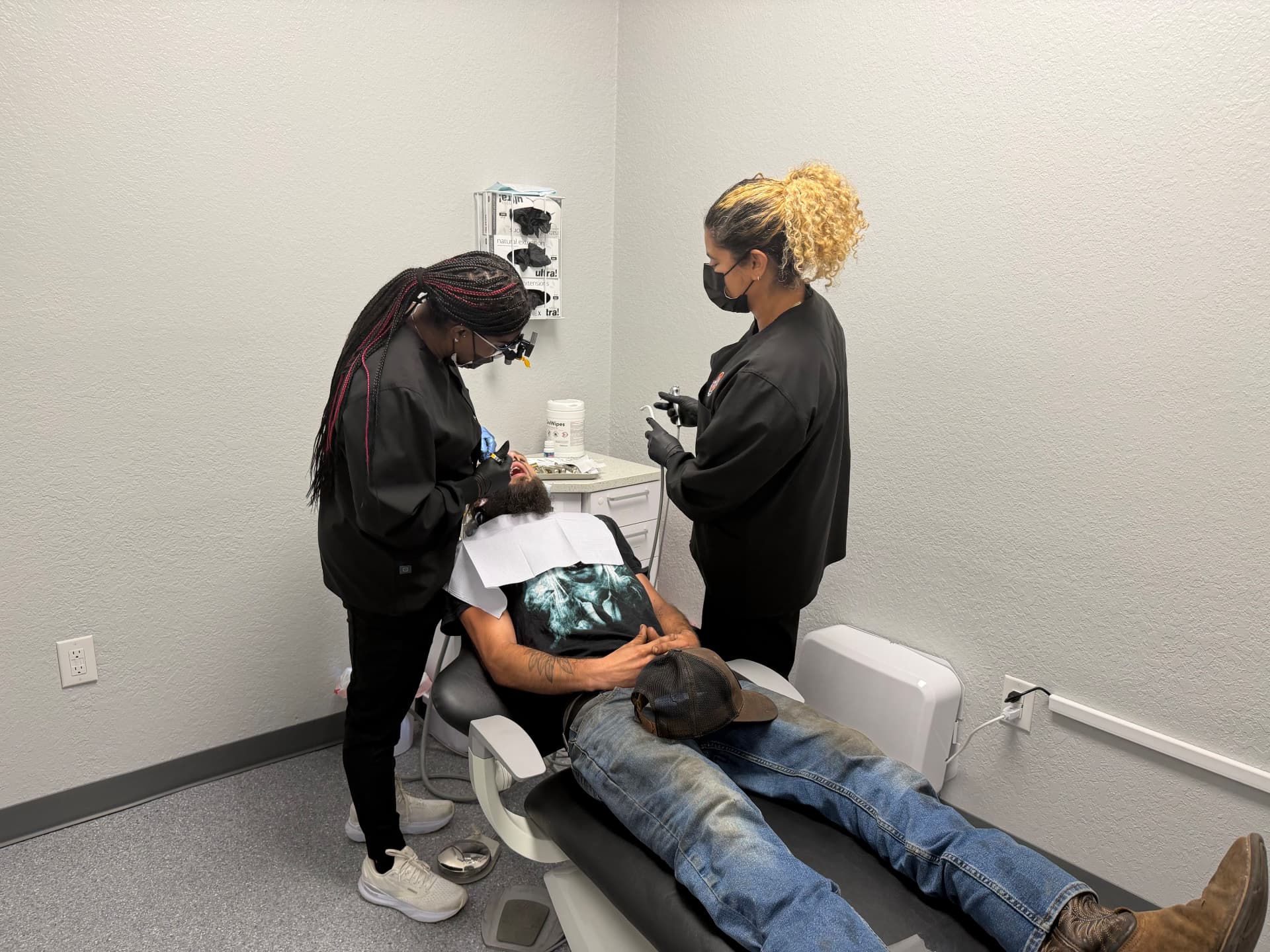 Dental team caring for a patient at the Just Pull It Port Richey office